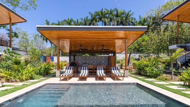 A swimming pool with lounge chairs and a covered seating area. - La Joya Amatista - Walk to Beach (Nosara)