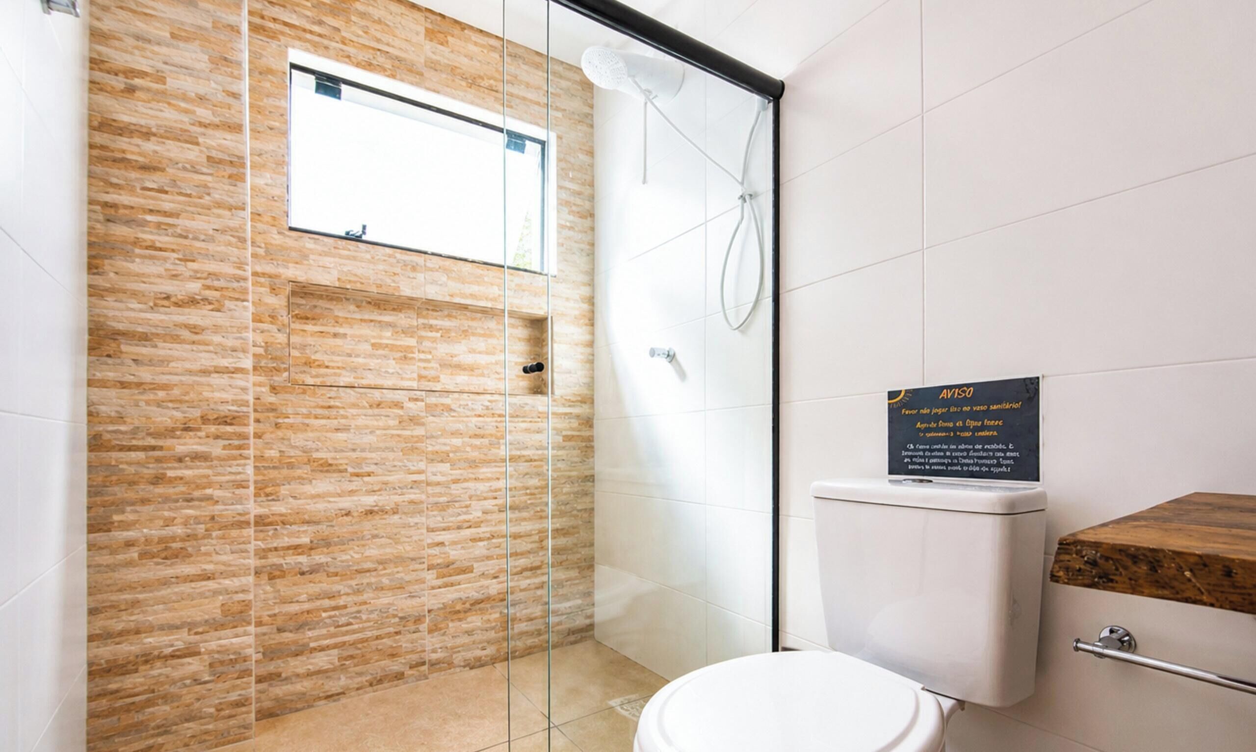 A modern bathroom with a glass shower enclosure, a toilet, and a wooden vanity.
