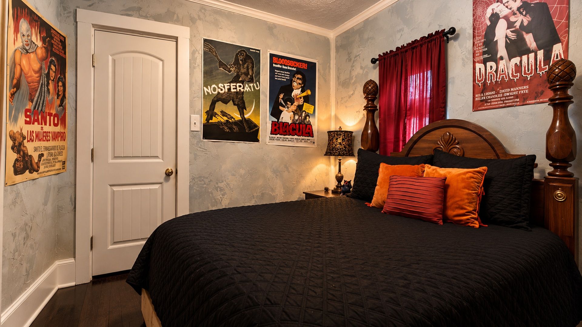 A bedroom with a bed, posters, a door, and a nightstand.