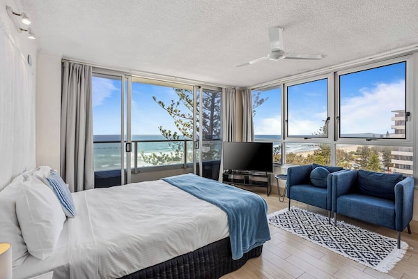 Wake up to breathtaking views across the ocean from your plush studio apartment with a charming balconette on the beachfront at Surfers Paradise.