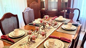 A dining table set with plates, cups, and a decorative centerpiece. - Cozy Country Home 3BR 3BA, 3200 sq. ft. will make your stay truly unforgettable! (Lufkin)
