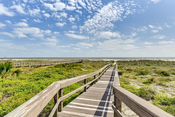 A wooden boardwalk leading to a beach with a clear sky. - Fernandina Beach Paradise: Steps to Shore! (Fernandina Beach)