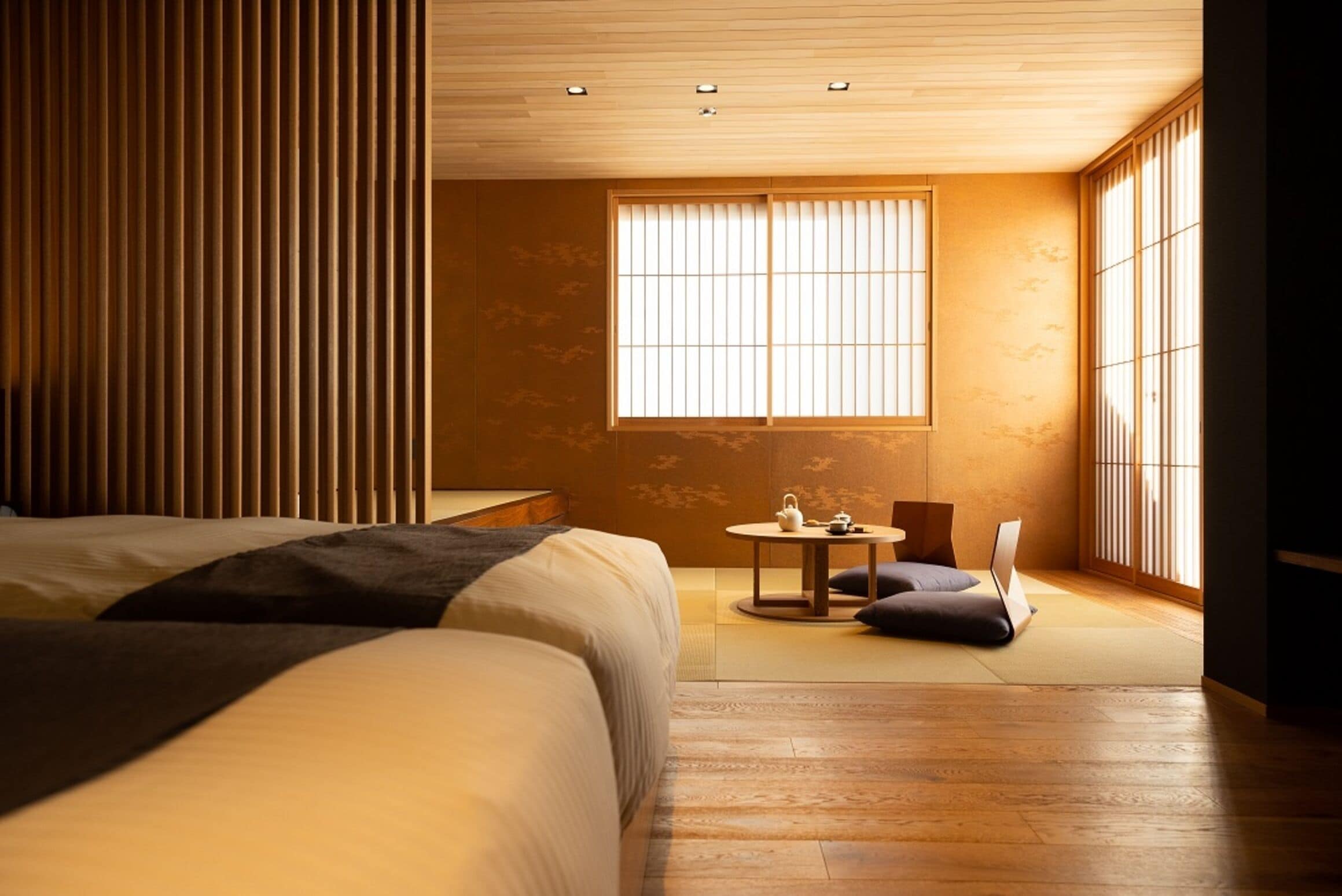 A traditional Japanese-style bedroom with tatami flooring, a low wooden ceiling, and sliding shoji doors.