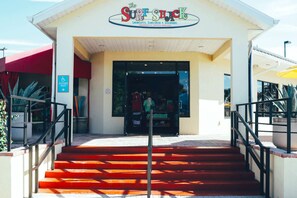 The entrance to a building with a sign reading "The Surf Shack" and a wheelchair accessible route sign.