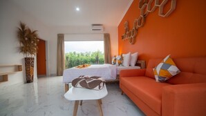 A hotel room with a bed, a sofa, a small table, and a potted plant. - MODERN COZY PRIVATE 2BR VILLA WITH ROOF TOP SUNSET VIEW (Bali)