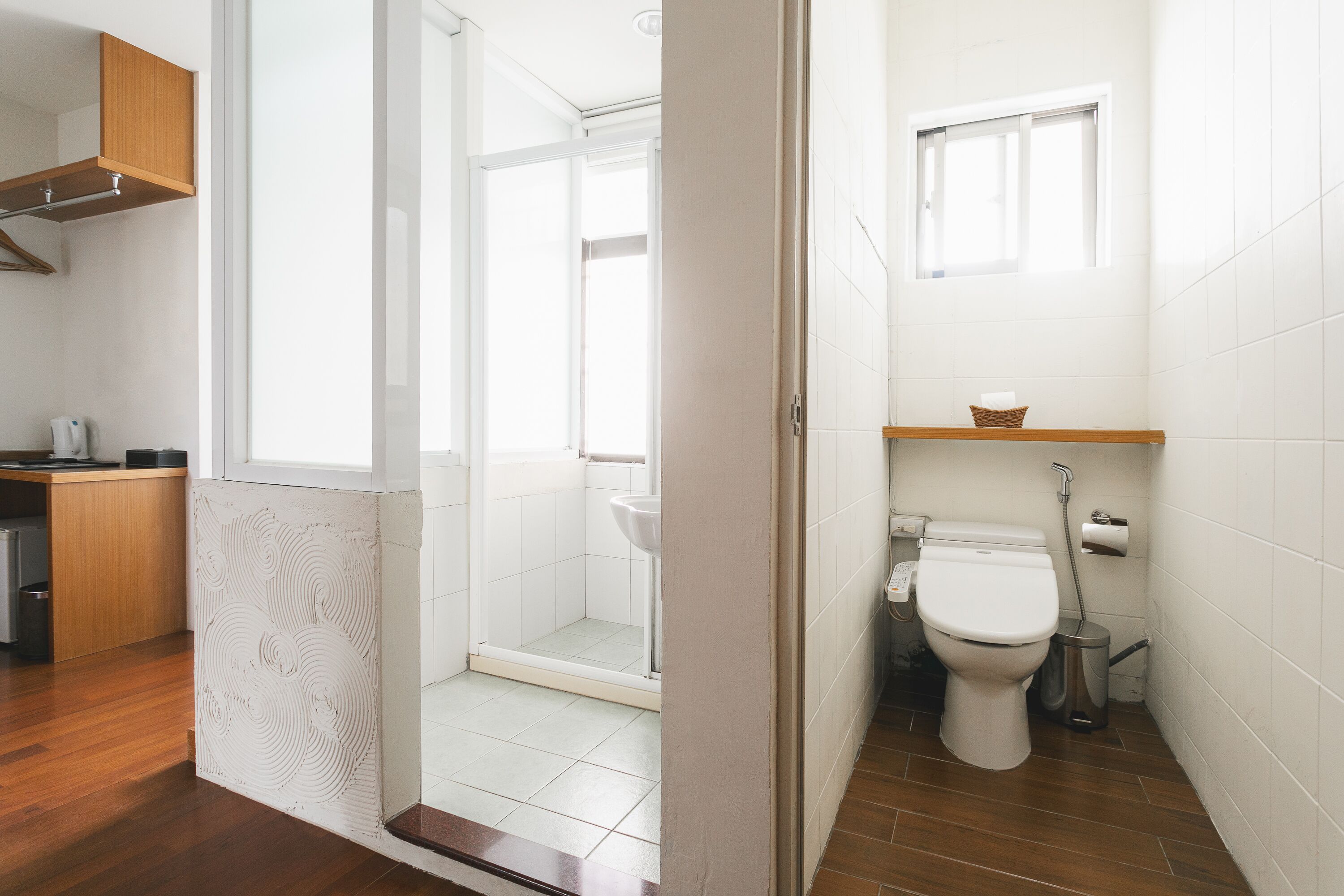 A modern bathroom with a shower, toilet, and sink.