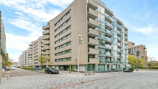 A modern multi-story residential building with balconies, a paved courtyard, and a clear sky. - Stay by the coastal trails, Middelkerke (Middelkerke)