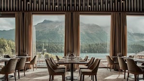 A restaurant with a mountain view, large windows, and a modern interior design. - Hotel GRACE LA MARGNA ST MORITZ (St. Moritz)