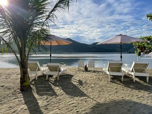 On the beach, sun-loungers, beach umbrellas, beach bar