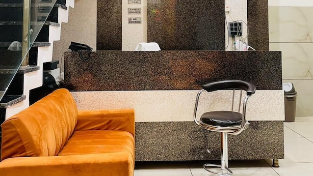 A modern reception area with a staircase, a reception desk, and a bar area. - Hotel 4S Niwas (Amritsar)