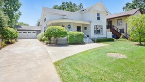 A two-story house with a garage, a well-maintained lawn, and a small front yard with a trimmed bush. - Comfortable Downtown Napa Victorian - quiet & convenient
 (Napa)
