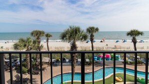 A pool area with a view of the beach and ocean. - Coastal Comfort: Oceanfront Jr Suite 3rd Floor (Myrtle Beach)