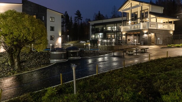 A modern hotel with a spacious outdoor area, including a pool and seating. - Vuokatti Booking Suites   (Sotkamo)