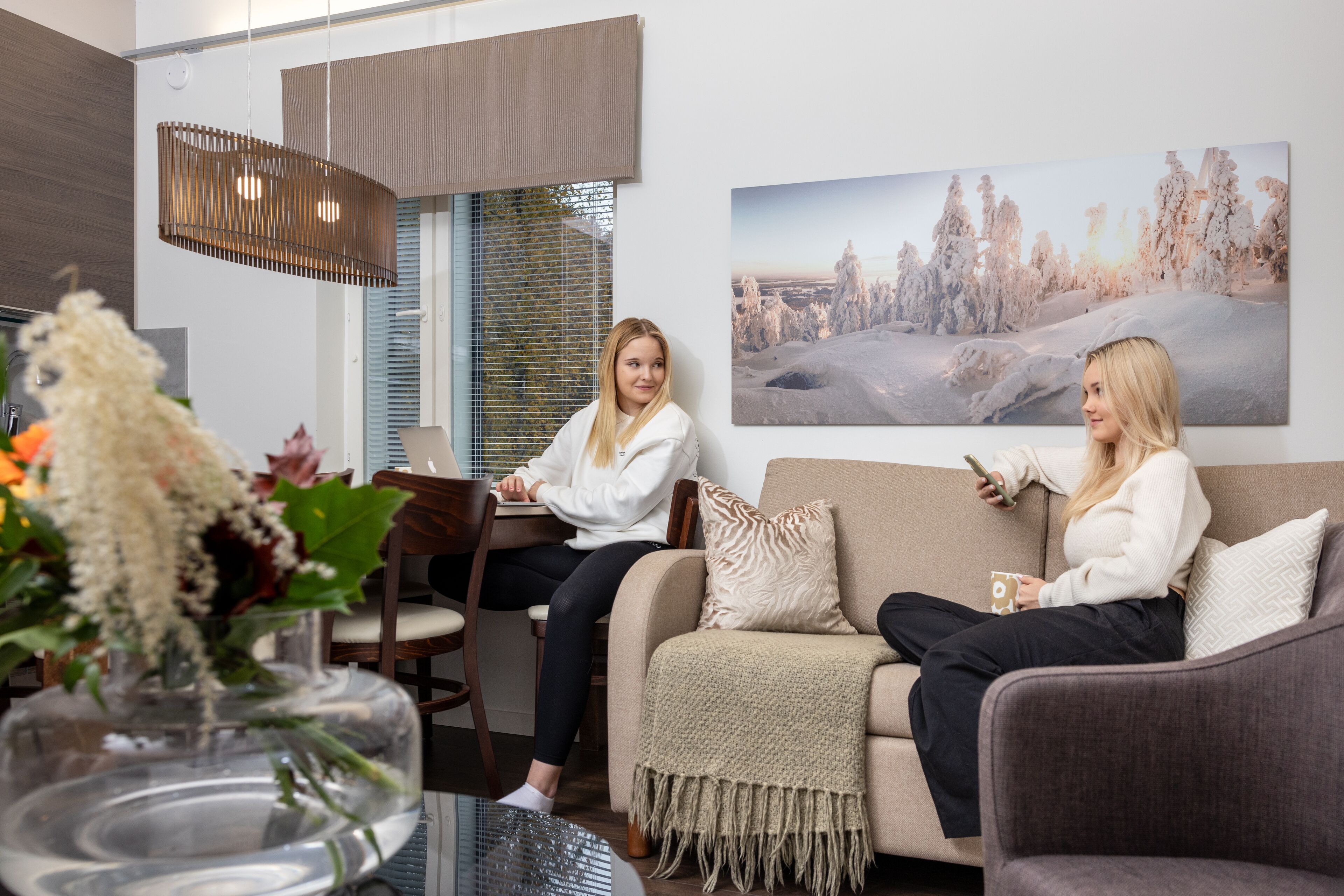 A modern living room with a sofa, a coffee table, and a dining area with a chair and a table.