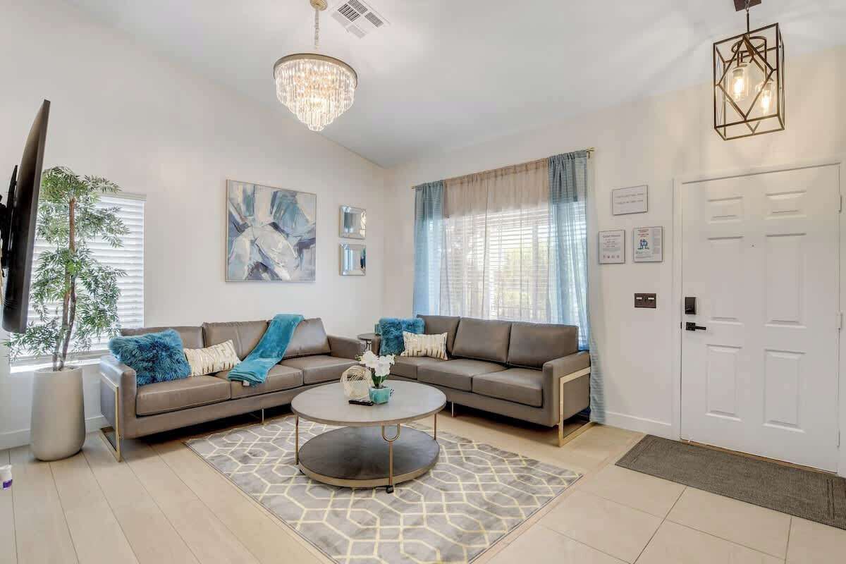 A modern living room with a sofa, coffee table, and decorative items.