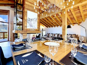 Enjoy meals in this cozy cabin's dining area, complete with a large table and comfortable seating.