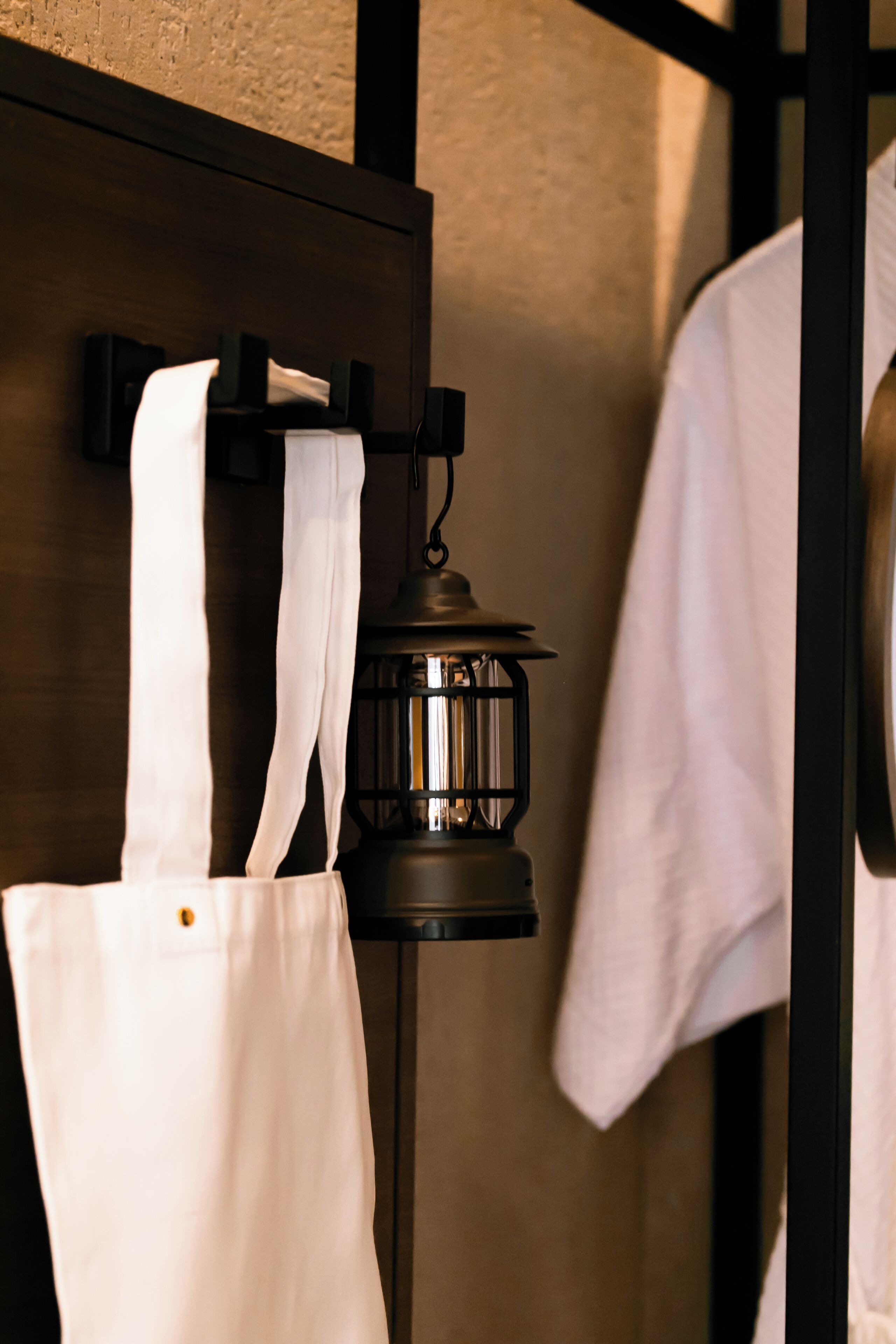 A wall-mounted lantern with a white cloth hanging from it.