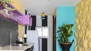 A kitchen with a black and white checkered floor, a sink, a refrigerator, and a potted plant. - Eclectic1BR in Talpiot mkt by Sea N Rent (Haifa)