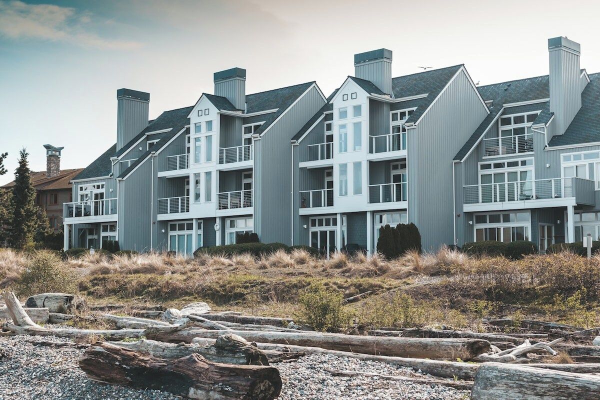A multi-story building with a symmetrical facade, large windows, and a flat roof.