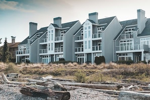 A multi-story building with a symmetrical facade, large windows, and a flat roof.