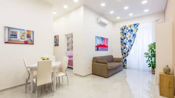 Deluxe Apartment | Living area | 32-inch LCD TV with satellite channels