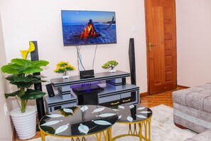 Executive Apartment | Living area | 50-inch Smart TV with digital channels, Netflix, streaming services - Isomer Comfort Homes (Nakuru)