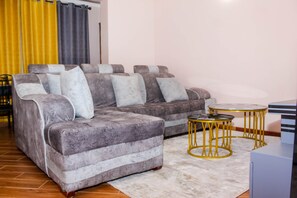 Executive Apartment | Living area | 50-inch Smart TV with digital channels, Netflix, streaming services - Isomer Comfort Homes (Nakuru)