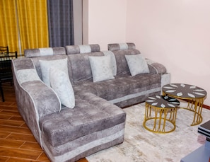Executive Apartment | Living area | 50-inch Smart TV with digital channels, Netflix, streaming services - Isomer Comfort Homes (Nakuru)