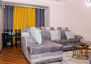 Executive Apartment | Living area | 50-inch Smart TV with digital channels, Netflix, streaming services - Isomer Comfort Homes (Nakuru)