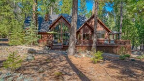 A cabin with a deck, surrounded by trees. - Wishram Retreat - 24 Wishram Trail (Graeagle)