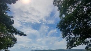 A concrete viewing platform with stone railings, overlooking a calm lake with distant hills under a partly cloudy sky. - Webster Lake Escape! (Franklin)