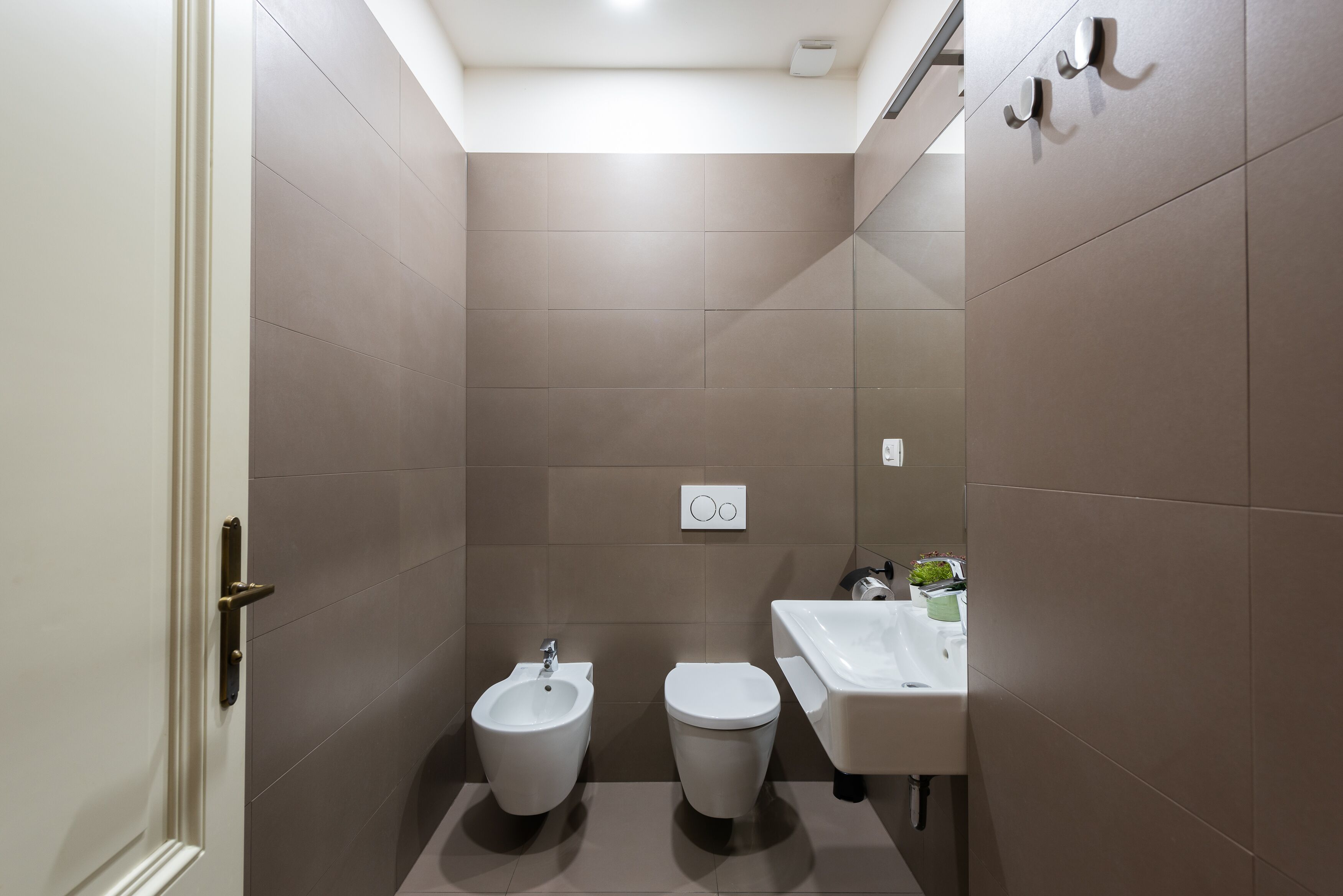 Un bany modern amb bidet, vàter i rentapins.
