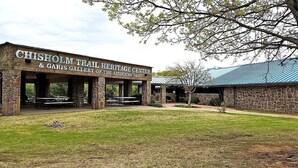 The Chisholm Trail Heritage Center with stone architecture and outdoor seating. - OK Welcome Home Hotel (Alva)