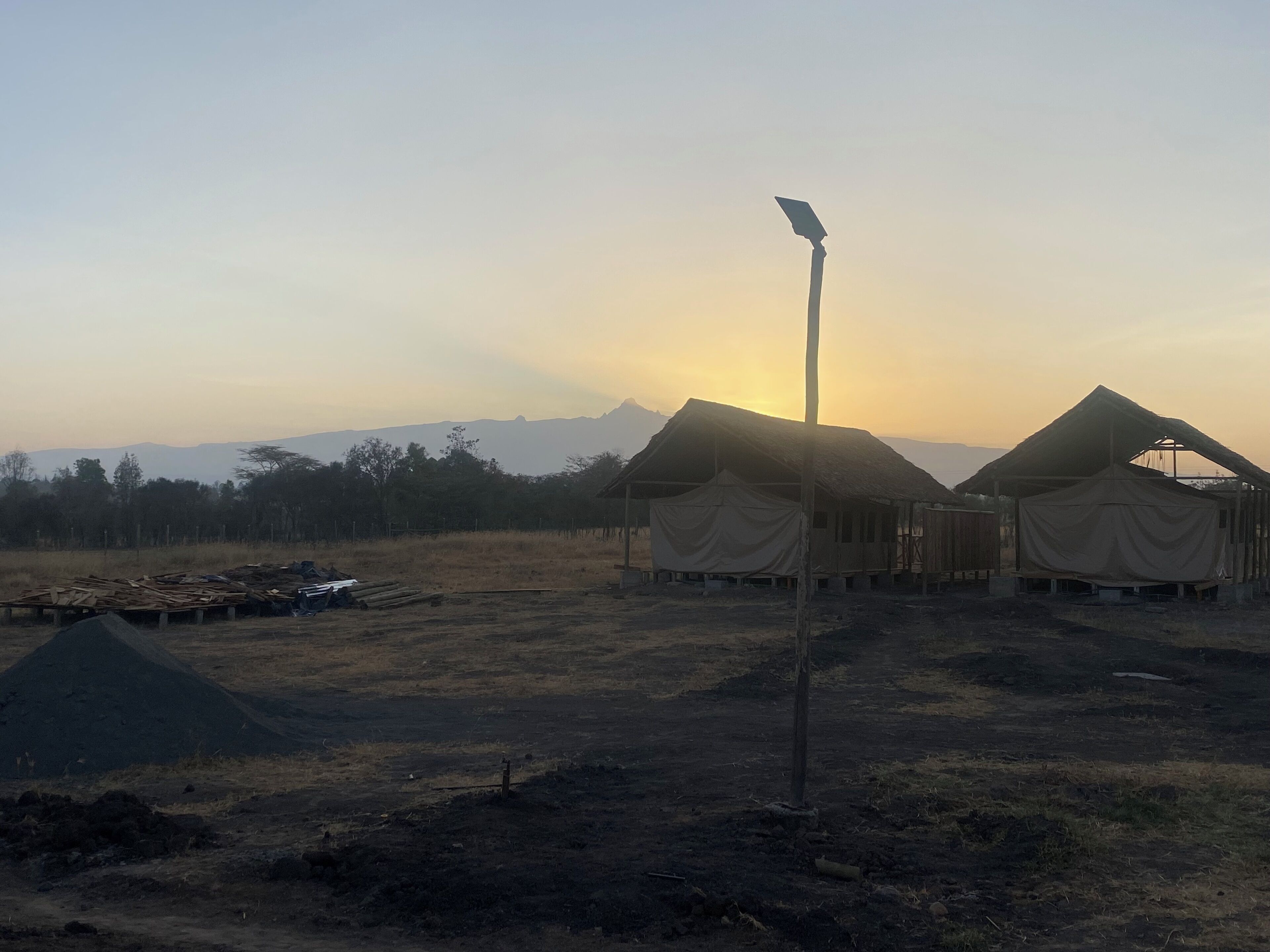 A campsite with tents and a solar panel.
