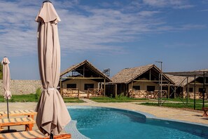 Outdoor pool, open 9:00 AM to 6:00 PM, pool umbrellas, pool loungers