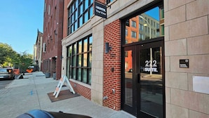 A brick building with large windows and a sign for "Suite 222".