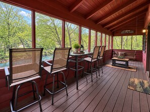 A covered outdoor seating area with a view of a natural landscape.