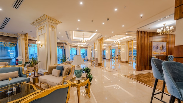 A spacious lobby with a grand chandelier, plush seating, and a large vase on a table. - Braira Al Jubail (Al Jubail)