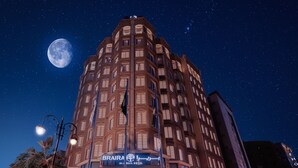 A multi-story hotel with a prominent sign for "BRAIRA ALJAIL HOTEL" against a night sky with stars and a visible moon. - Braira Al Jubail (Al Jubail)