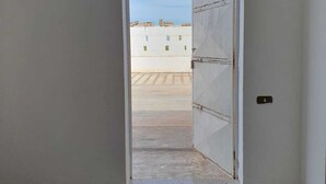 A room with a large open door leading to a rooftop area. - Cozy, warm and in a strategic neighborhood (Nardò)
