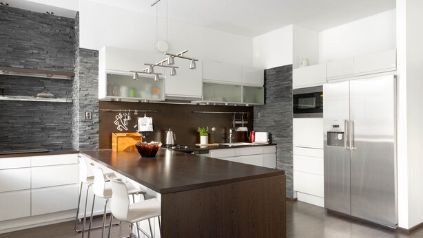 A modern kitchen with a central island, white cabinetry, and stainless steel appliances. - Spacious apt on Tranquil Courtyard (Helsinki)