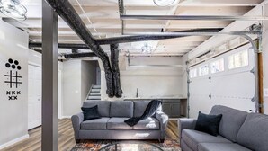 A modern living room with a gray sofa, a glass coffee table, and a patterned rug. - The Blissful Hideaway w/ large backyard, jacuzzi and two connecting decks (Villa Rica)