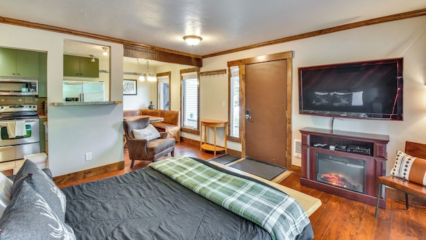 A cozy room with a bed, a fireplace, a TV, and a kitchenette. - Steamboat Springs Condo Near Ski Resort & Village! (Steamboat Springs)