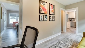 A modern interior with a dining area, kitchen, and living space. - Updated Atlanta Home ~ 5 Mi to Downtown! (Atlanta)