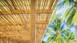 A pool area with a view of the beach, thatched roof, and lounge chairs. - Boho Boutique Hotel - Beachfront , Adults Only , Private Pool (Kiwengwa)