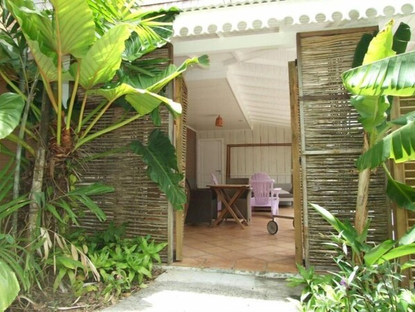 Relax in a serene outdoor space surrounded by lush greenery and comfortable seating.