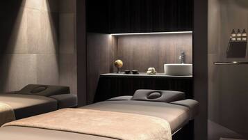 A modern bathroom with a large mirror, a sink, and a shelf with toiletries.
