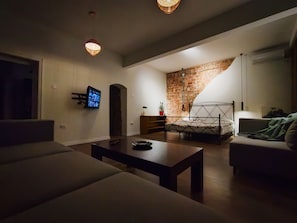Relax in a cozy living room with a sofa, coffee table, and fireplace.