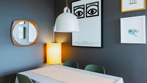 A modern dining area with a table, chairs, a hanging lamp, and framed artwork on the wall. - Central Location Flat near Old St and Dalston Overlooking Rosemary Park and Regents Canal - Pass the Keys (London)