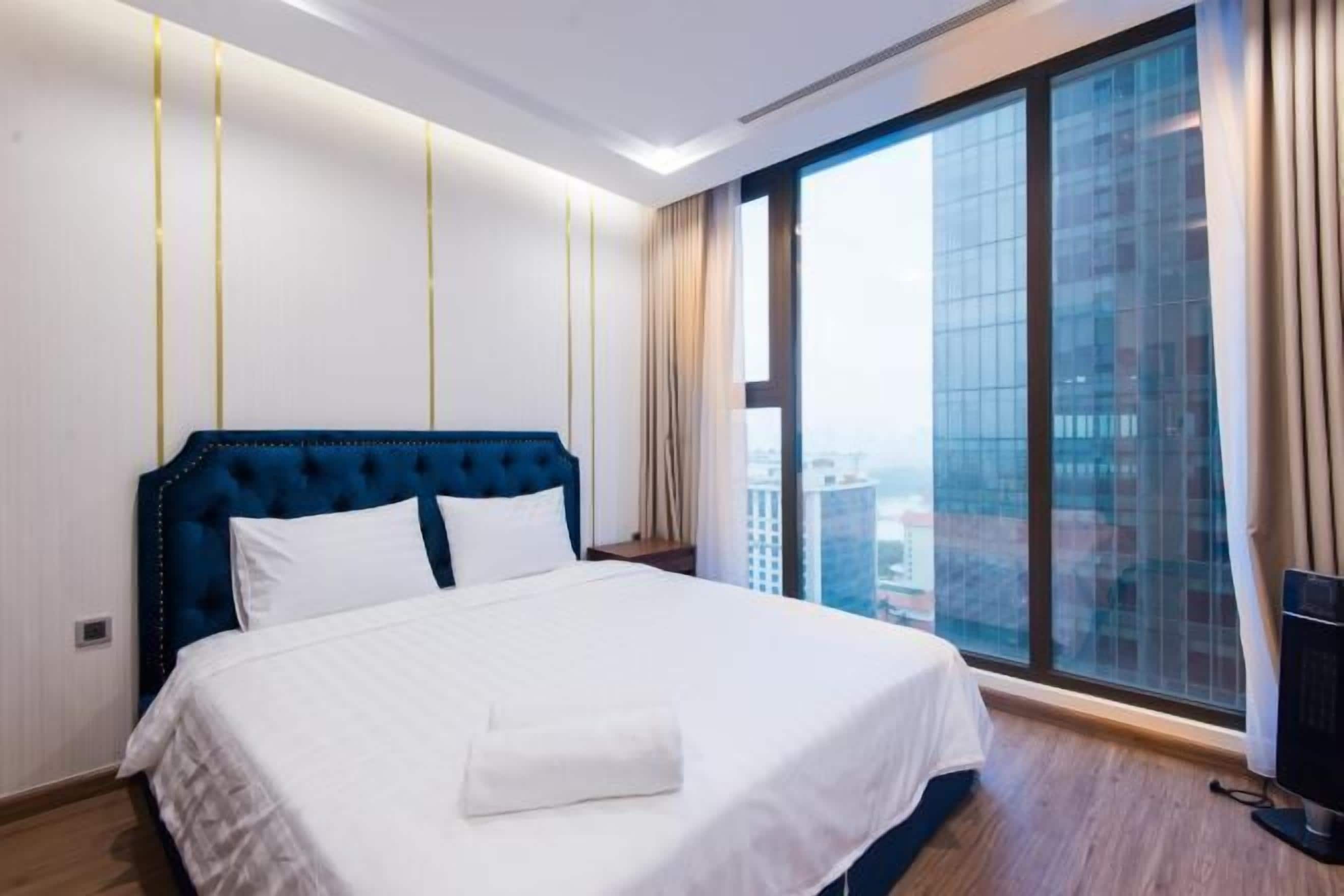 Premium bedding, desk, laptop workspace, blackout drapes